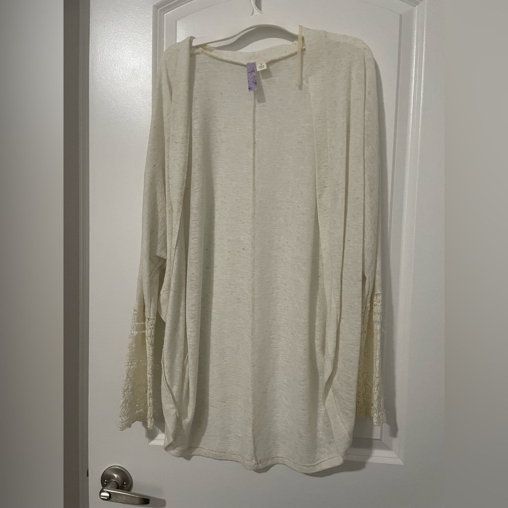 Cream colored cardigan with crochet detail on sleeves